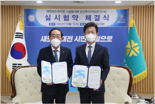 최광호(왼쪽)한화건설 부회장과 허태정 대전시장이 10일 대전하수처리장 시설현대화 민간투자사업의 실시협약을 체결하고 기념사진을 촬영하고 있다. <한화건설 제공>